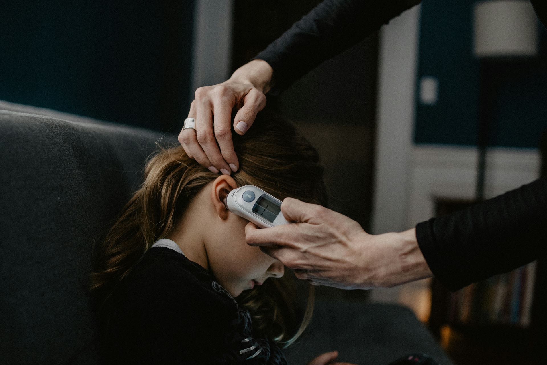 Photo of girl getting her temperature taken